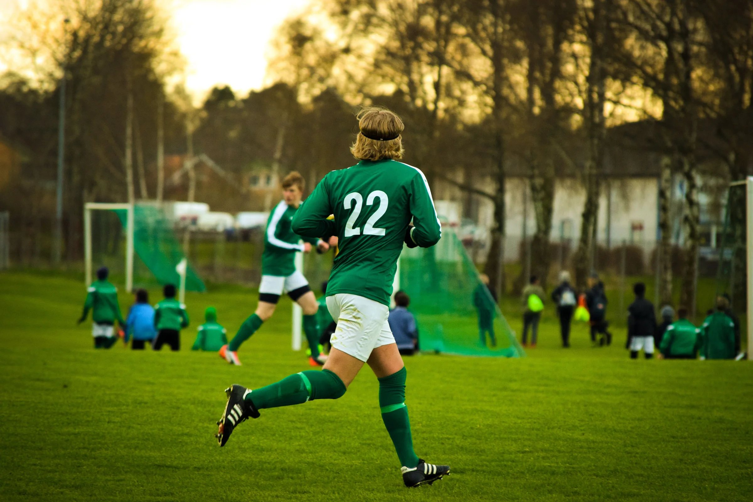 Athletes playing football on a field